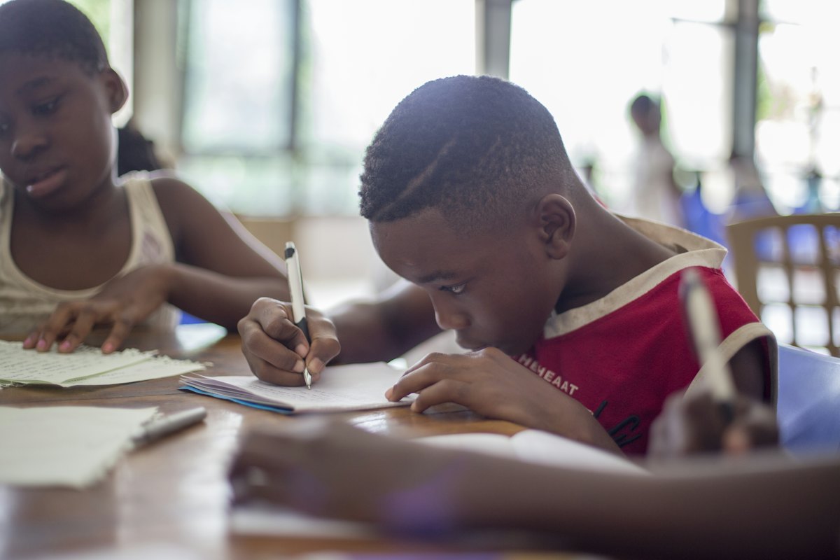 Children writing in notebooks